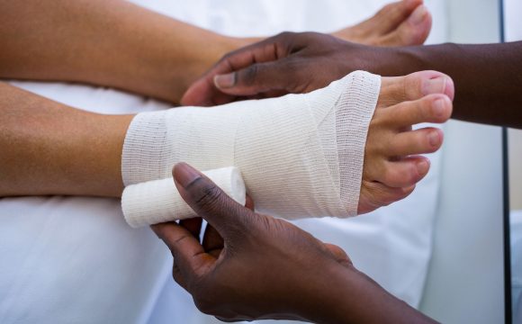 Doctor bandaging patient's leg